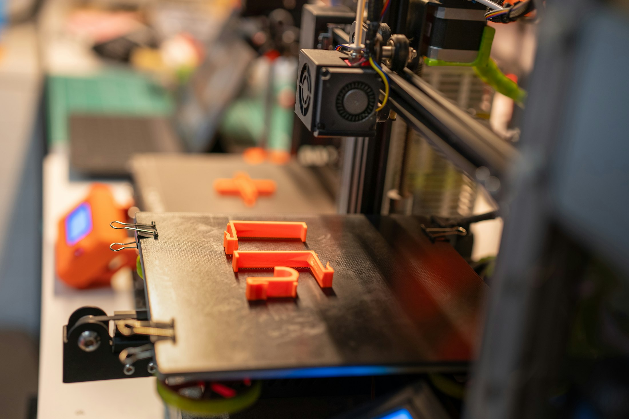 Finished orange parts on a print bed